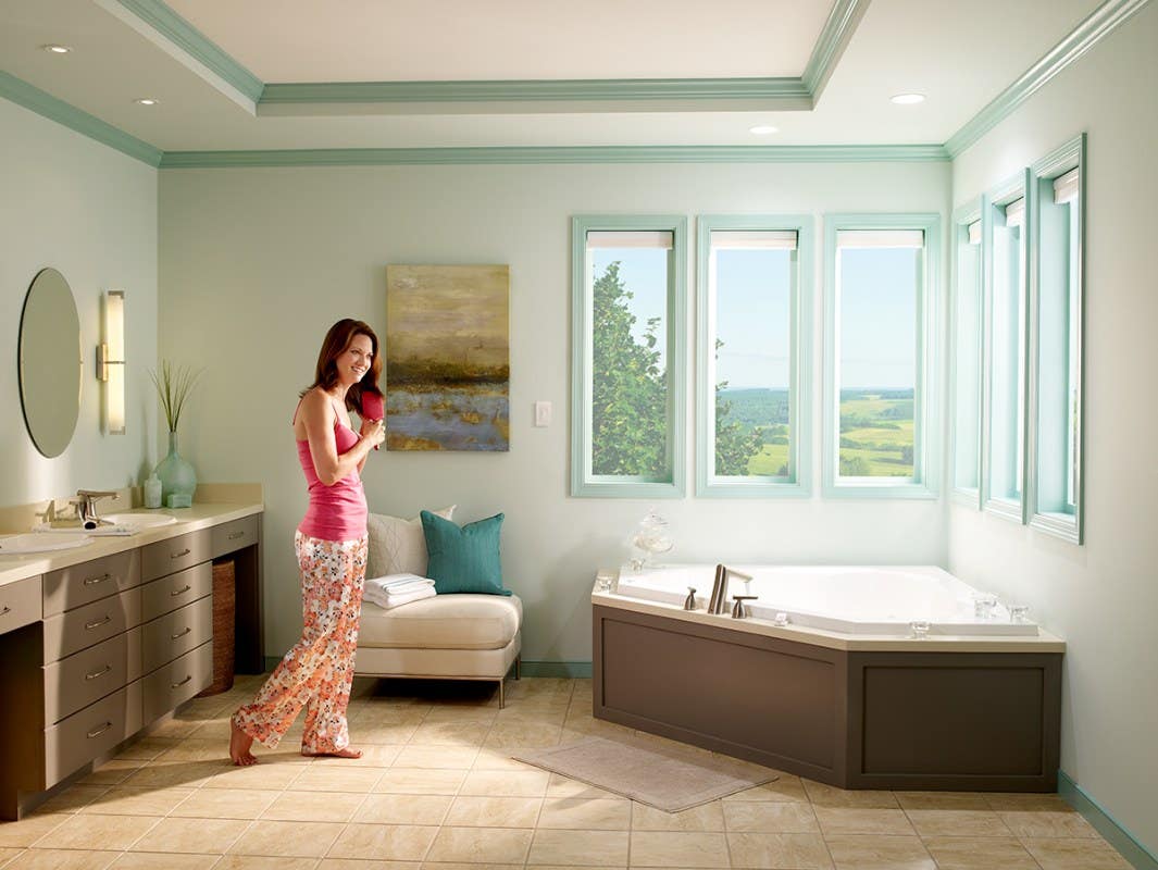 Woman in Bathroom with Opened Light Filtering Honeycomb Shades