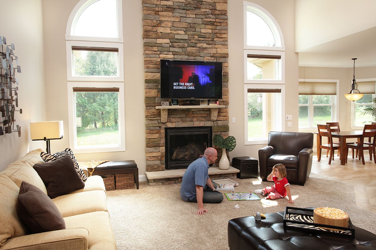 Man and Daughter in Living Room with Open Room Darkening Honeycomb Shades