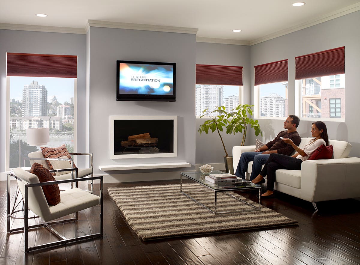 Man and Woman Sitting in Media Room with Partially Open Honeycomb Shades